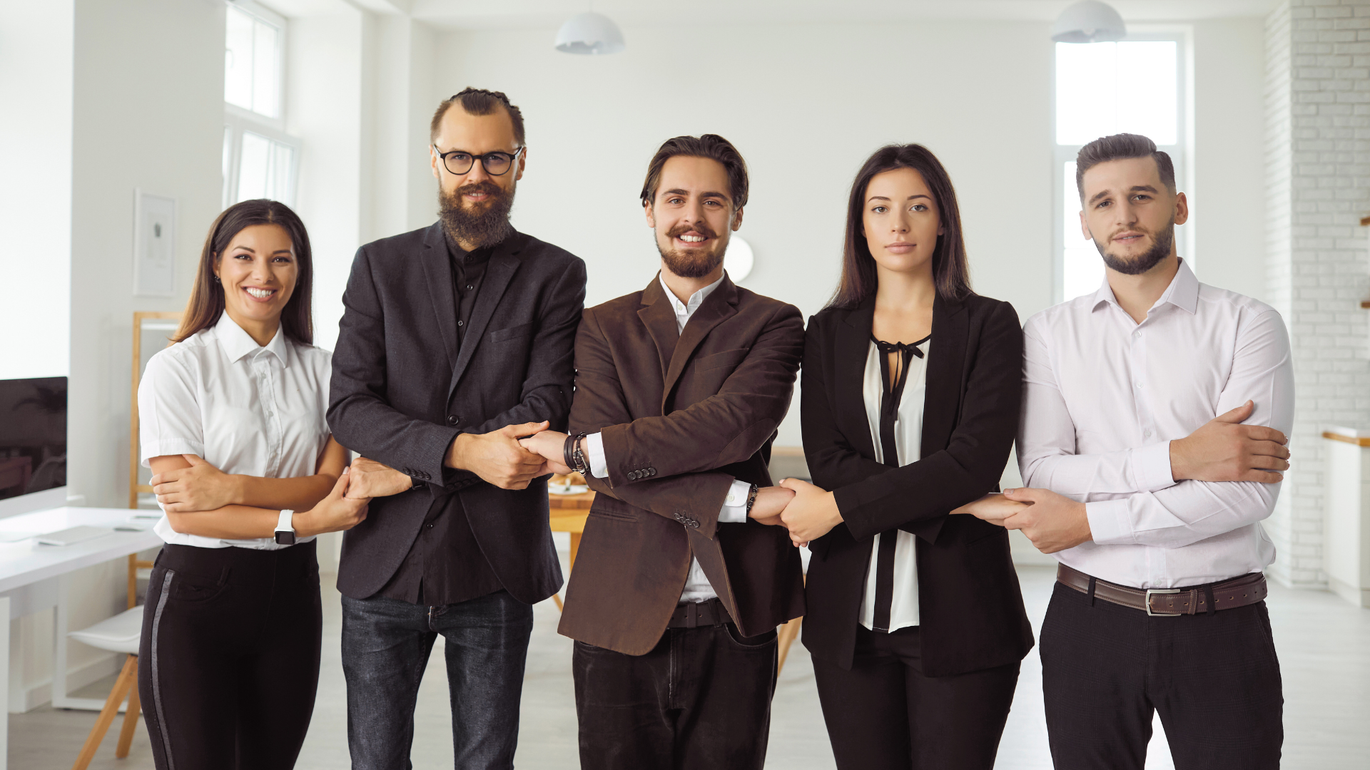 A group of business people are posing for a picture in an office.