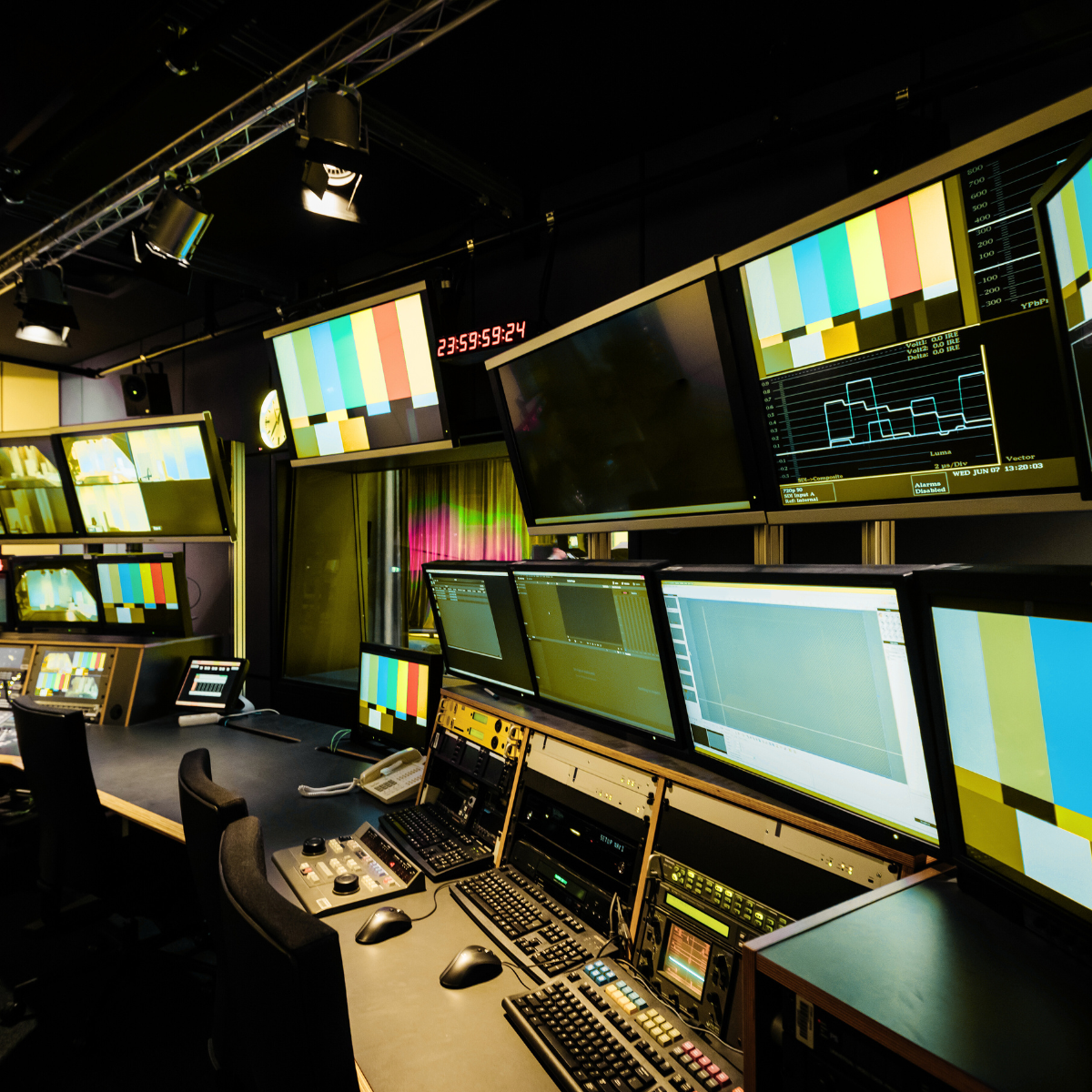 A room with a lot of monitors and a sign that says cbs