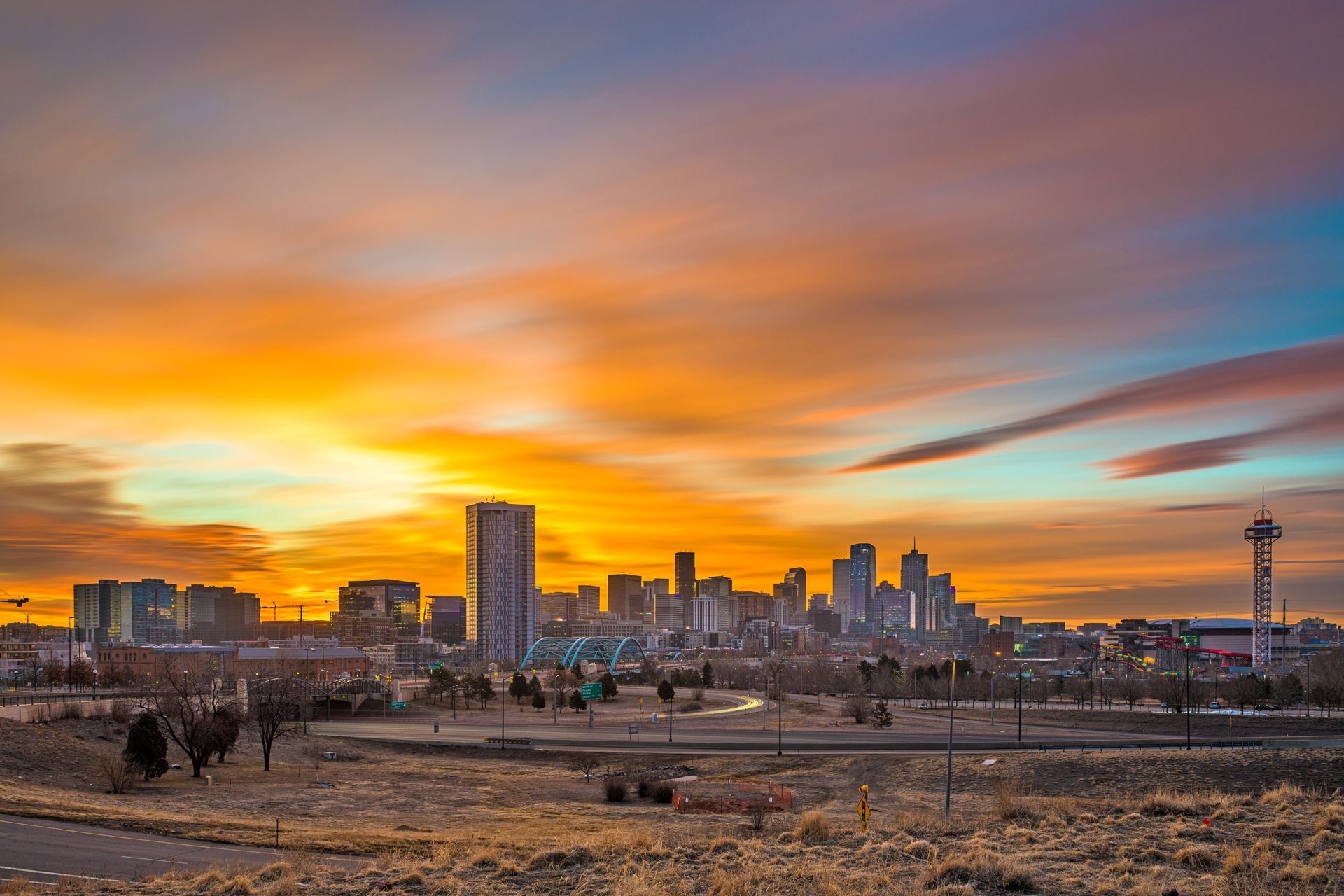 A city skyline at sunset with a sunset in the background.