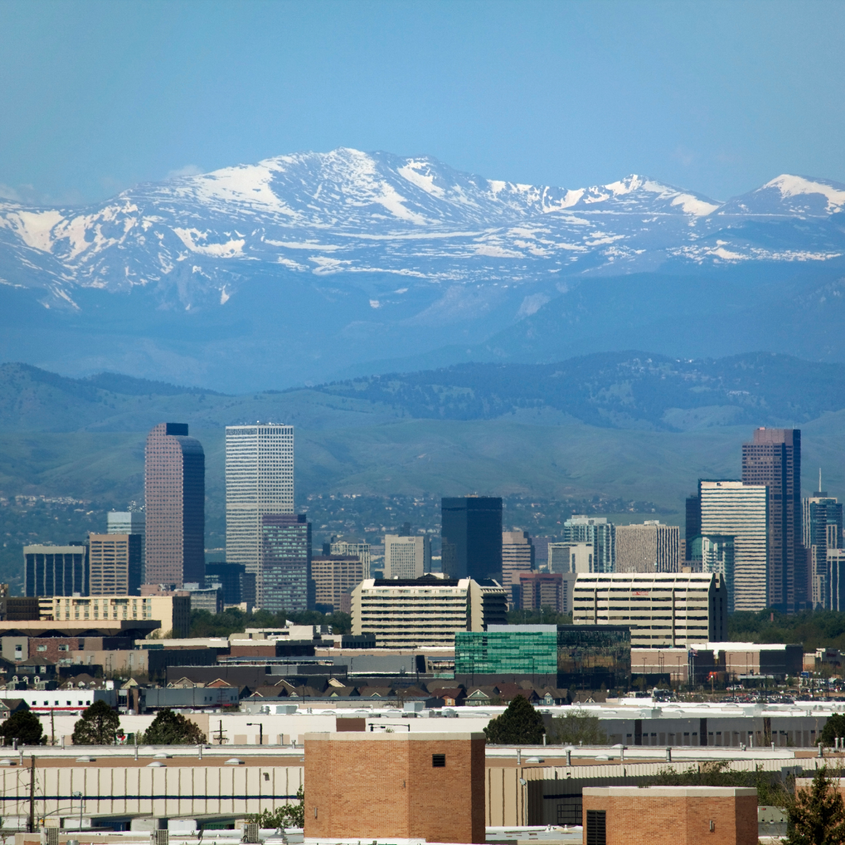 A city skyline with mountains in the background