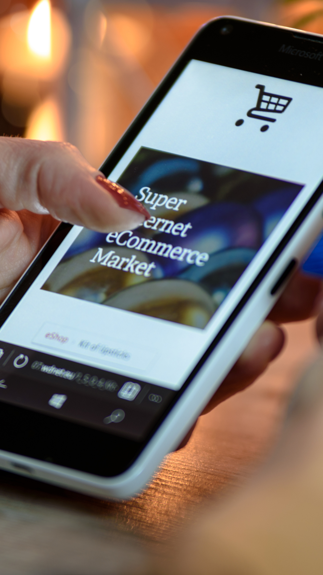 A person is holding a cell phone that says super internet commerce market