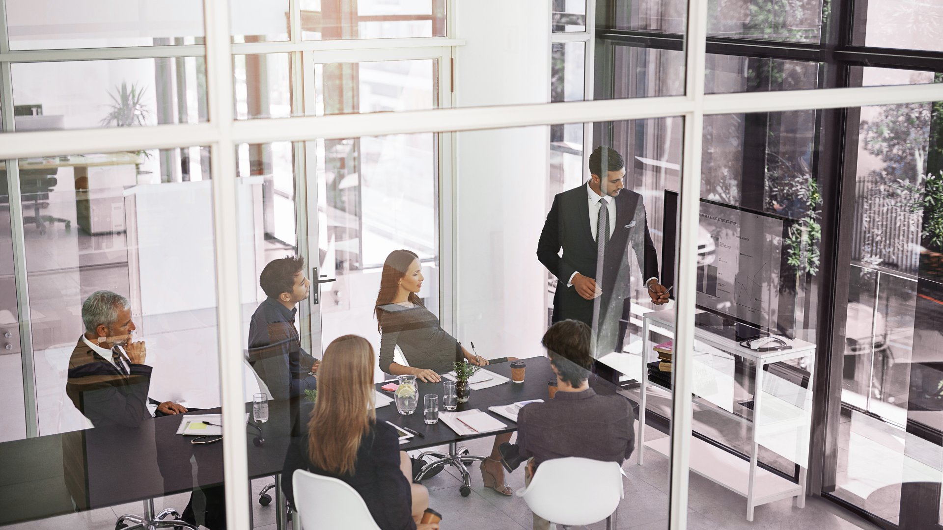 A group of business people are having a meeting in a conference room.