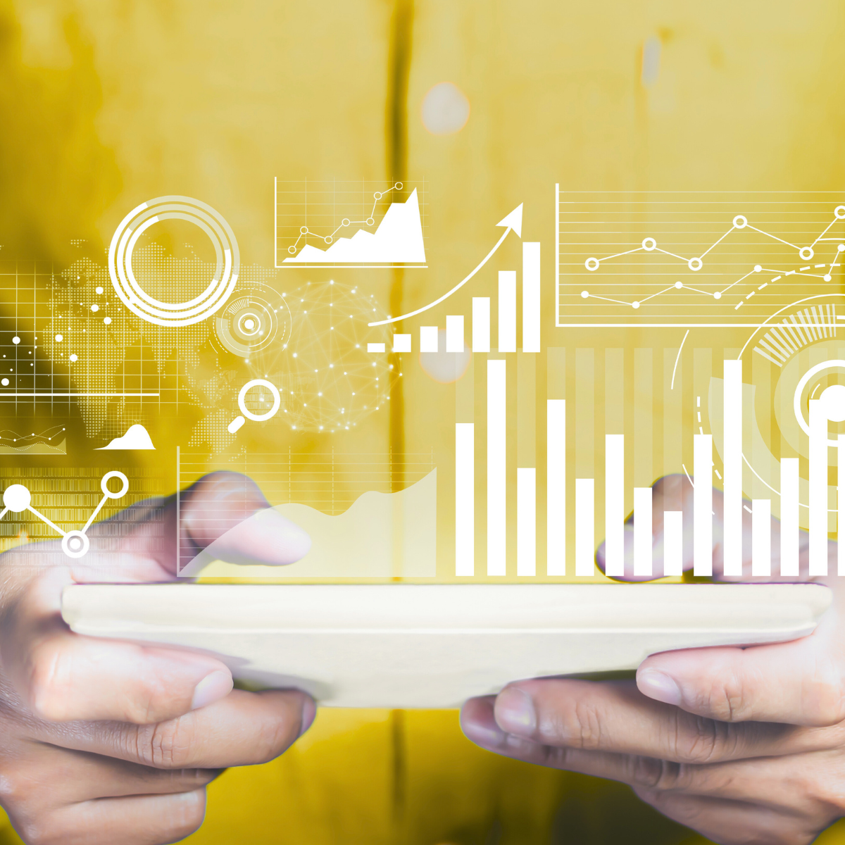 A person is holding a tablet with graphs and charts on it.