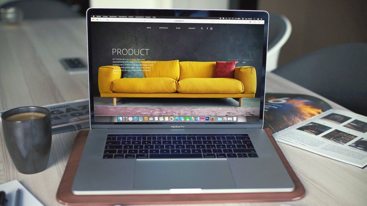 A laptop with a picture of a yellow couch on the screen.