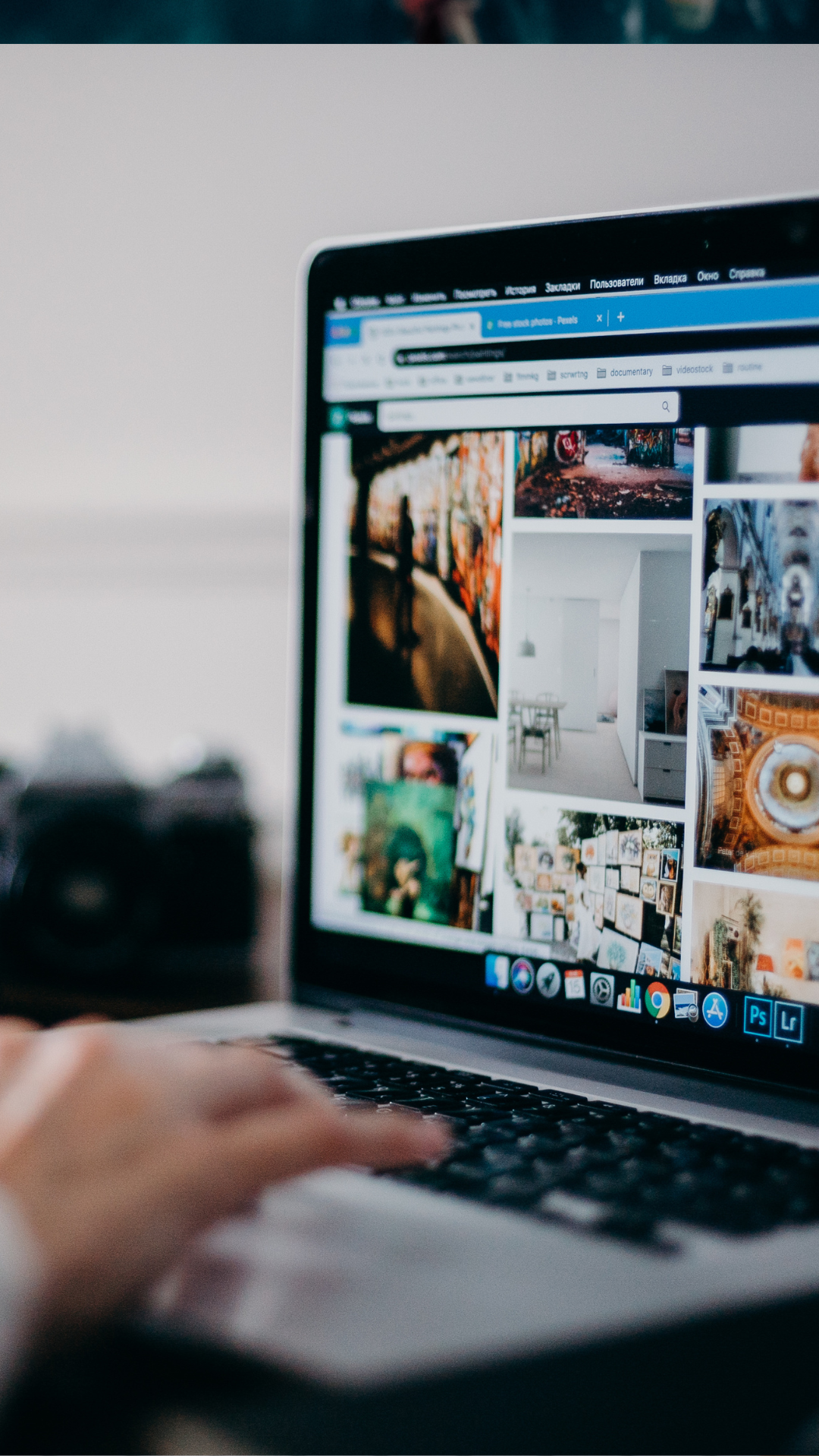 A person is using a laptop computer with a collage of pictures on the screen.