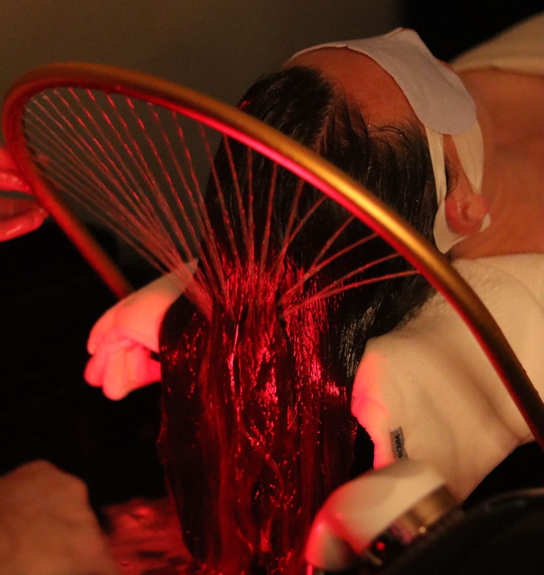 A woman is getting a head massage at a spa.