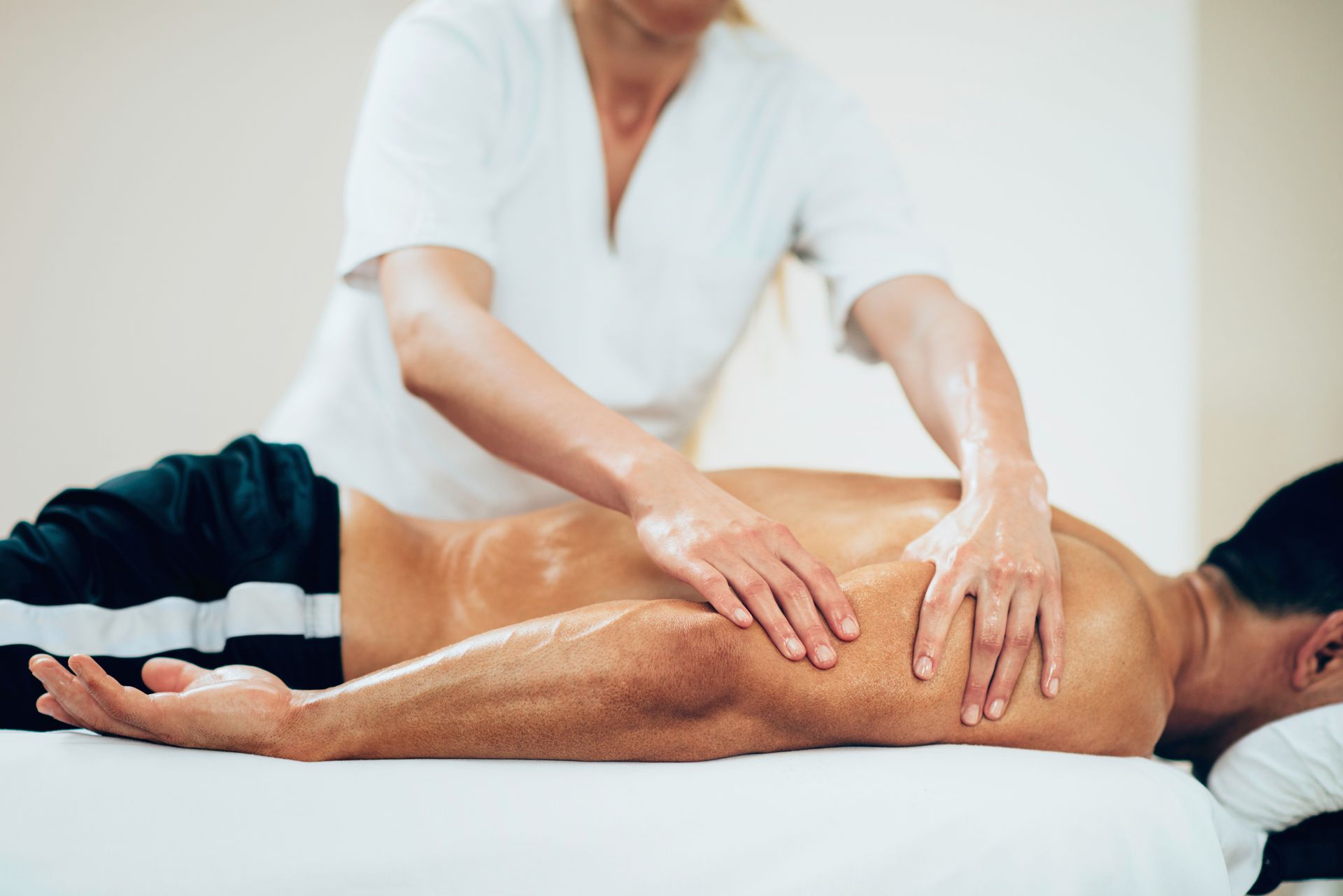 A man is getting a massage from a woman in a spa.