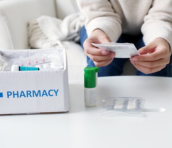 Woman Receive Medication Package — Crete, NE — Ken's Pharmacy