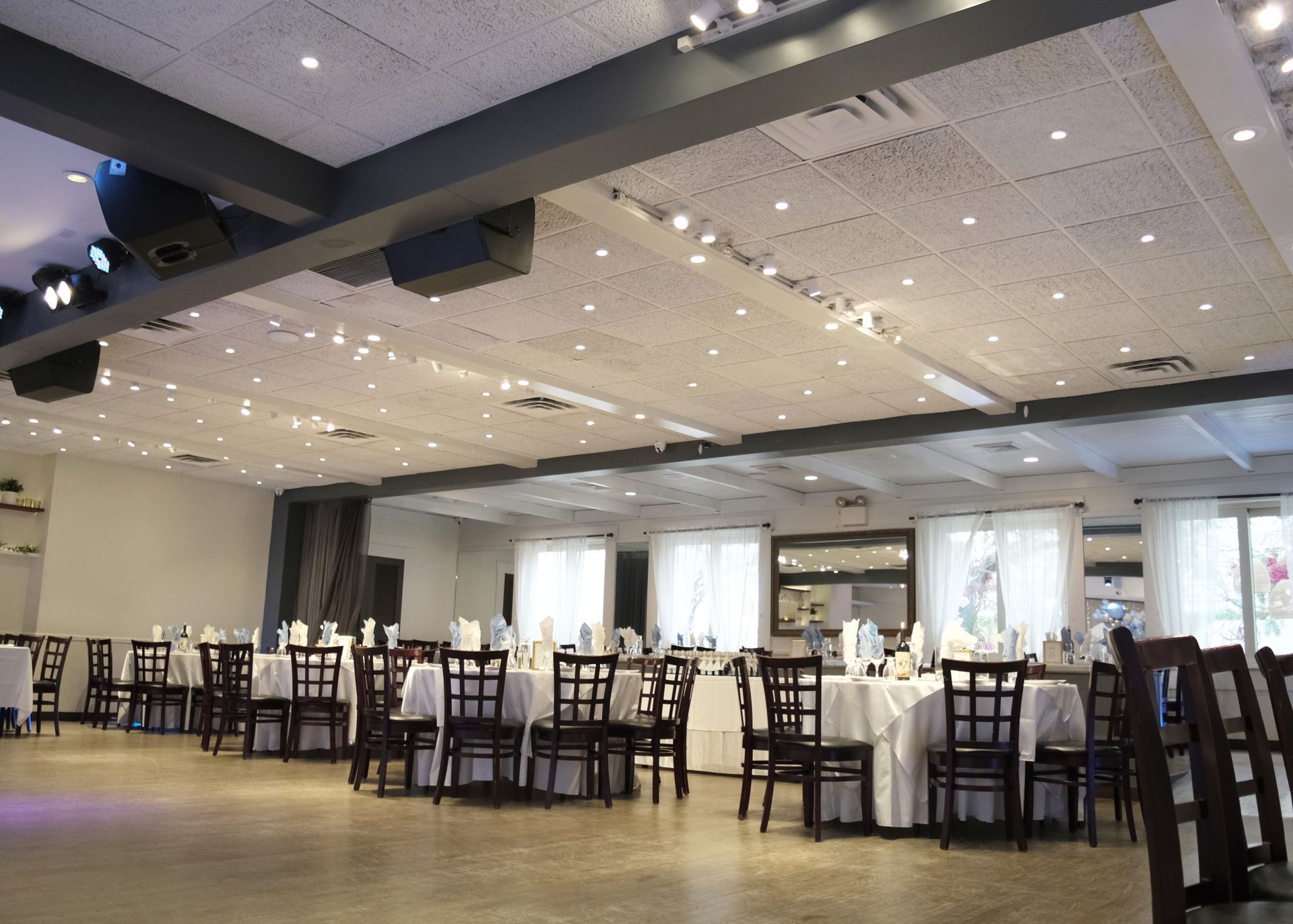 A large room with tables and chairs and a dance floor