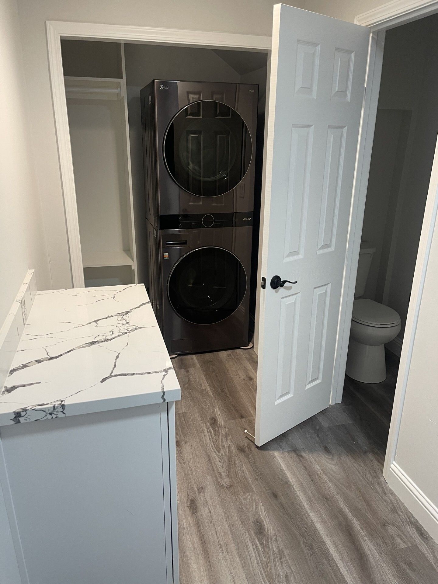 A washer and dryer are stacked on top of each other in a laundry room.
