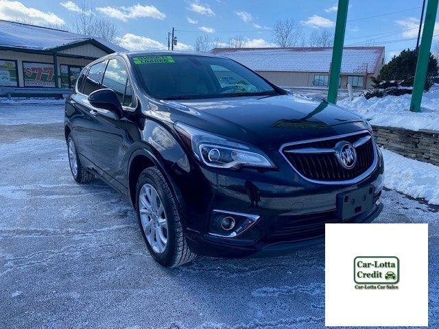 Black Buick SUV parked outside a business with snow on the ground.
