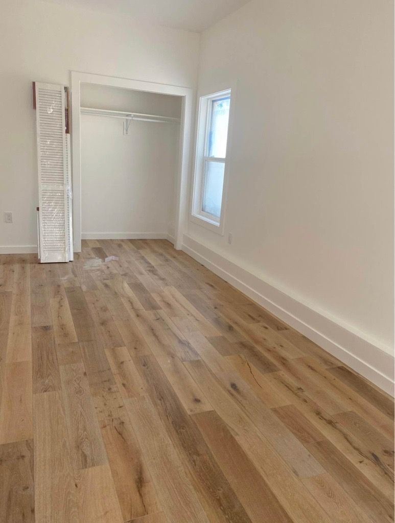 Empty room with light wood floors, a closet, and a small window. White walls and trim. Empty room with light wood floors, a closet, and a small window. White walls and trim.