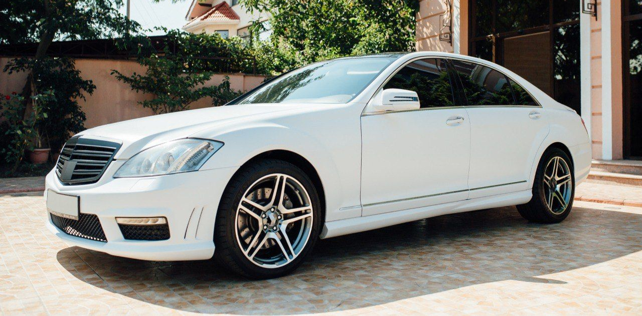auto tint technician using squeegee to install window film