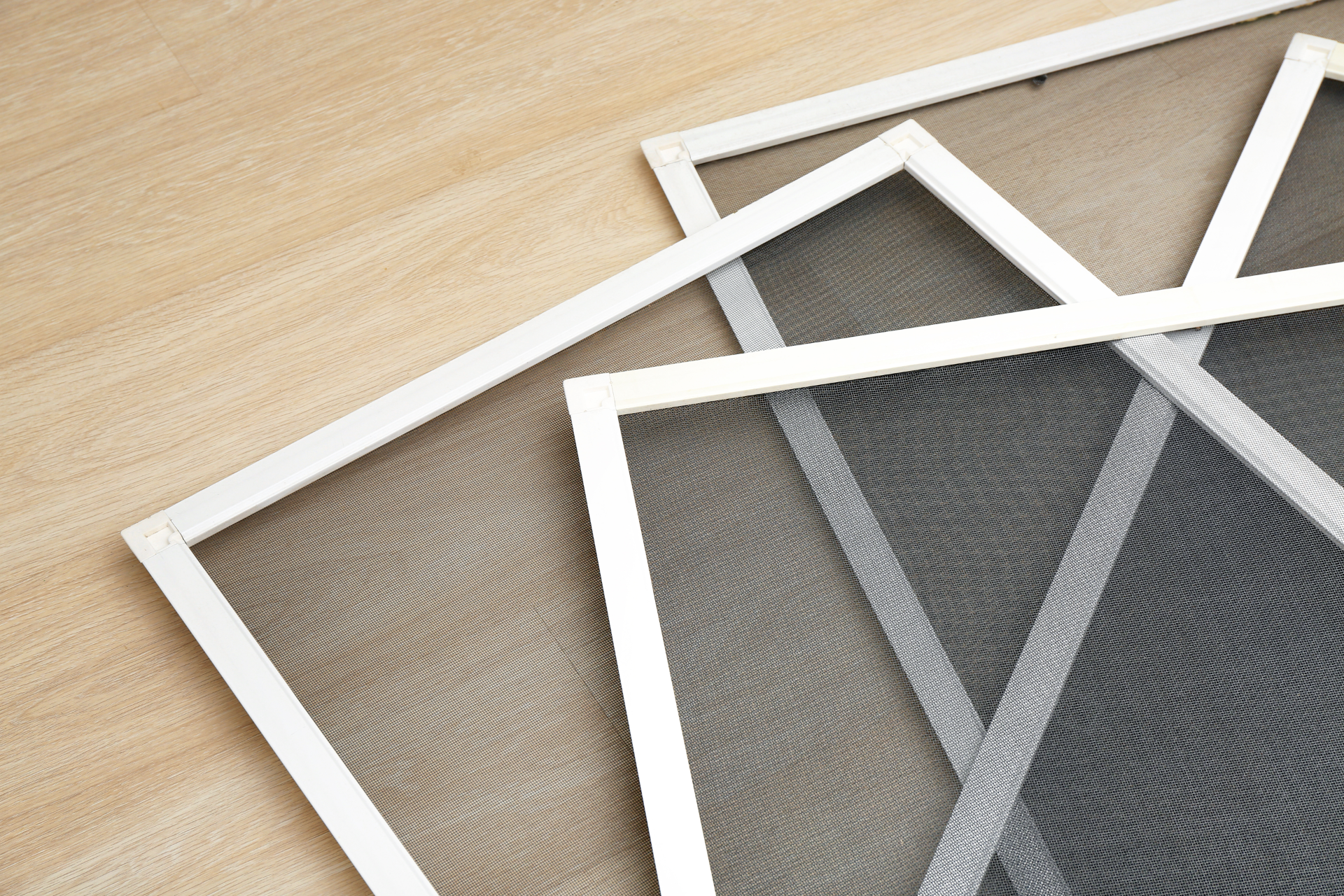 window screens laying on wood