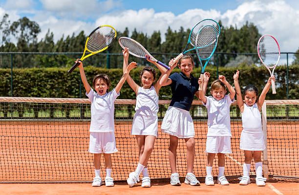 Happy kids playing tennis