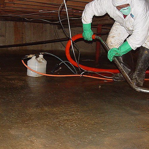 a water damage technician extracting water from a crawlspace in a south florida home