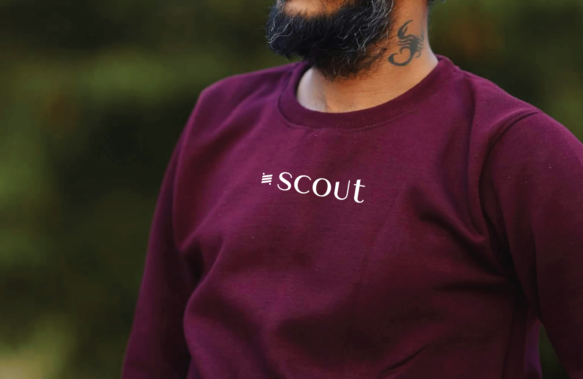 Person wearing a maroon sweatshirt with