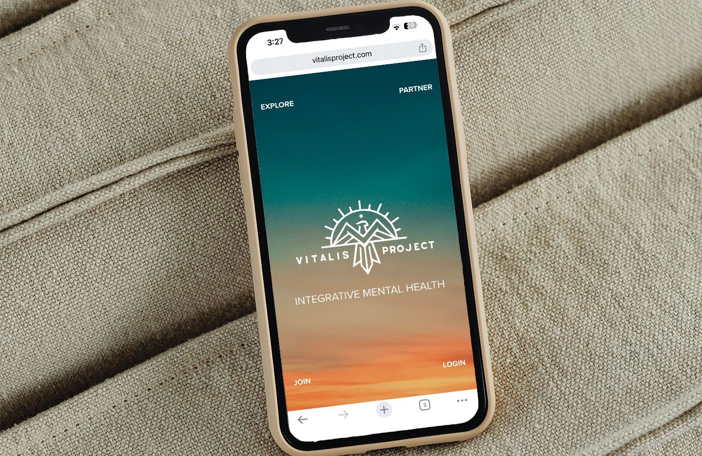 Smartphone displaying a website for the Vitalis Project, with a logo on an orange and teal gradient.
