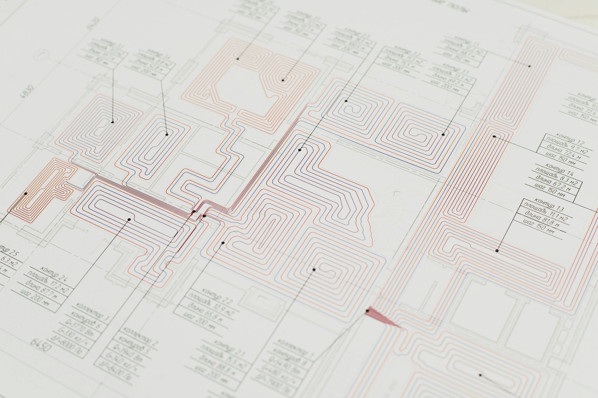 Blueprint with complex circuitry design, featuring red and black lines and text labels on a light background.