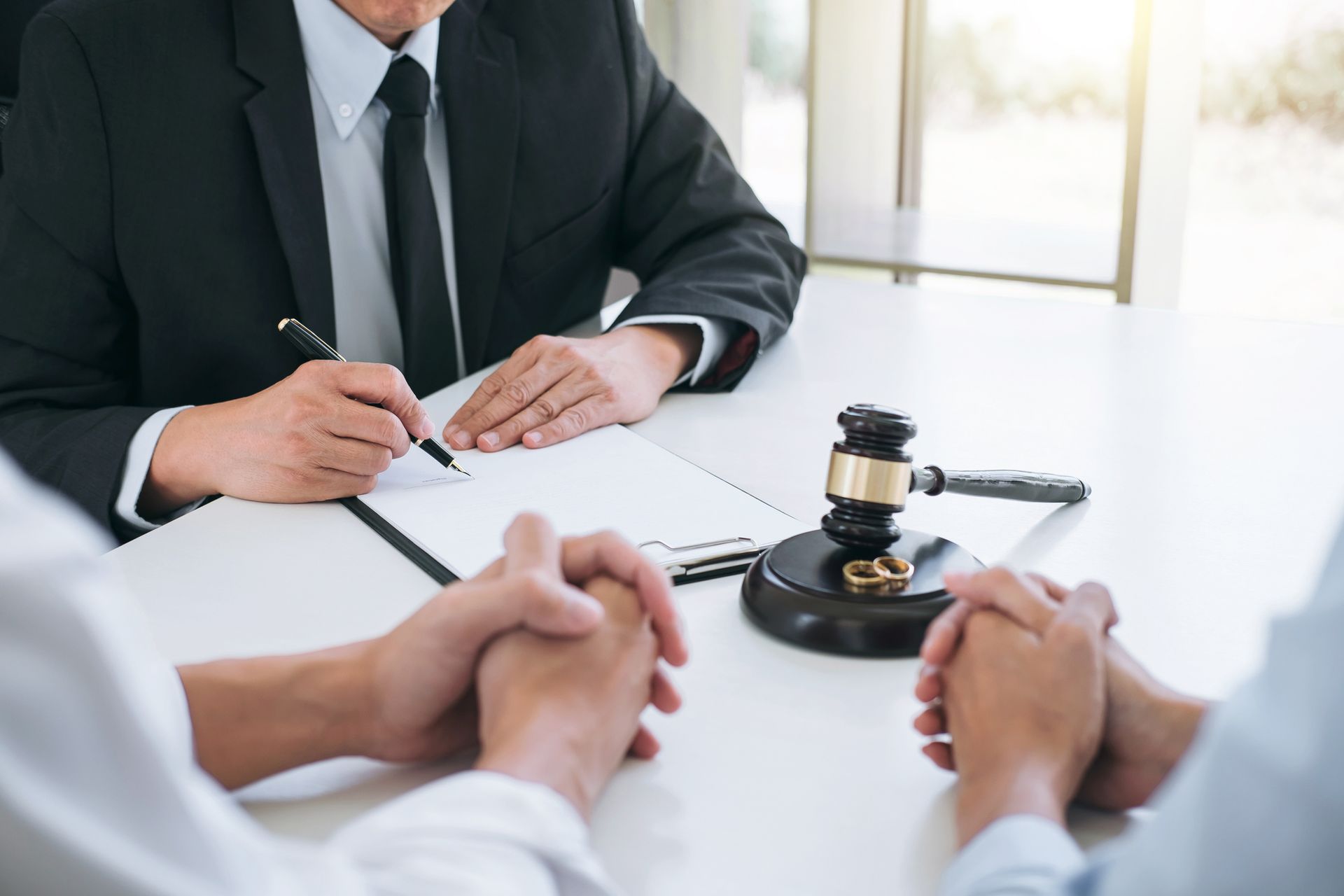 An agreement prepared by a high-end divorce attorney signing a decree of divorce for a couple. 