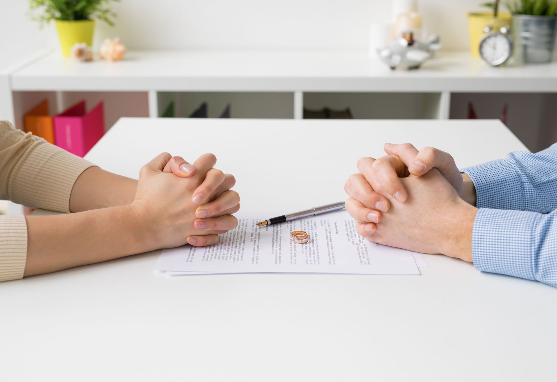 Couple going through divorce signing papers.