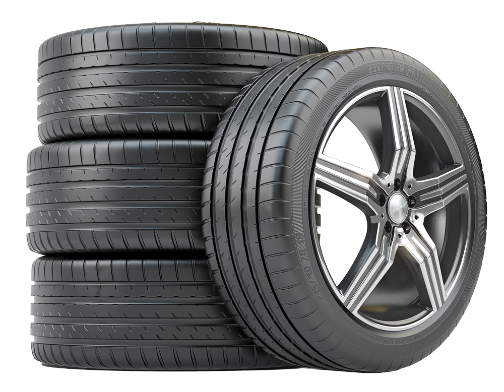Four black car tires stacked next to one tire mounted on a silver and black rim.