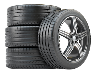 Tires stacked next to a wheel with a silver and black rim, ready for installation.