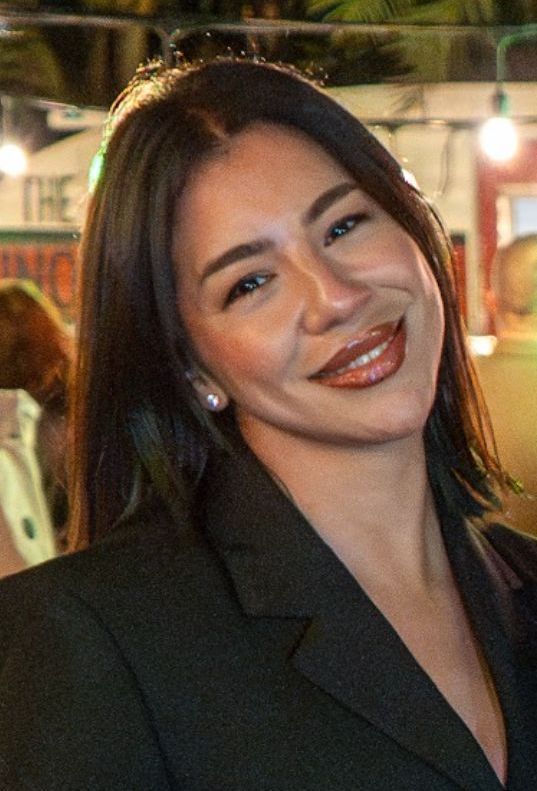 Barbie Concepcion is smiling for the camera.