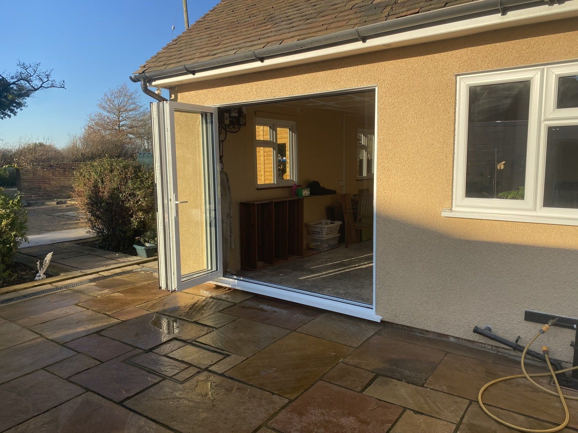 A house with a patio and a sliding glass door.
