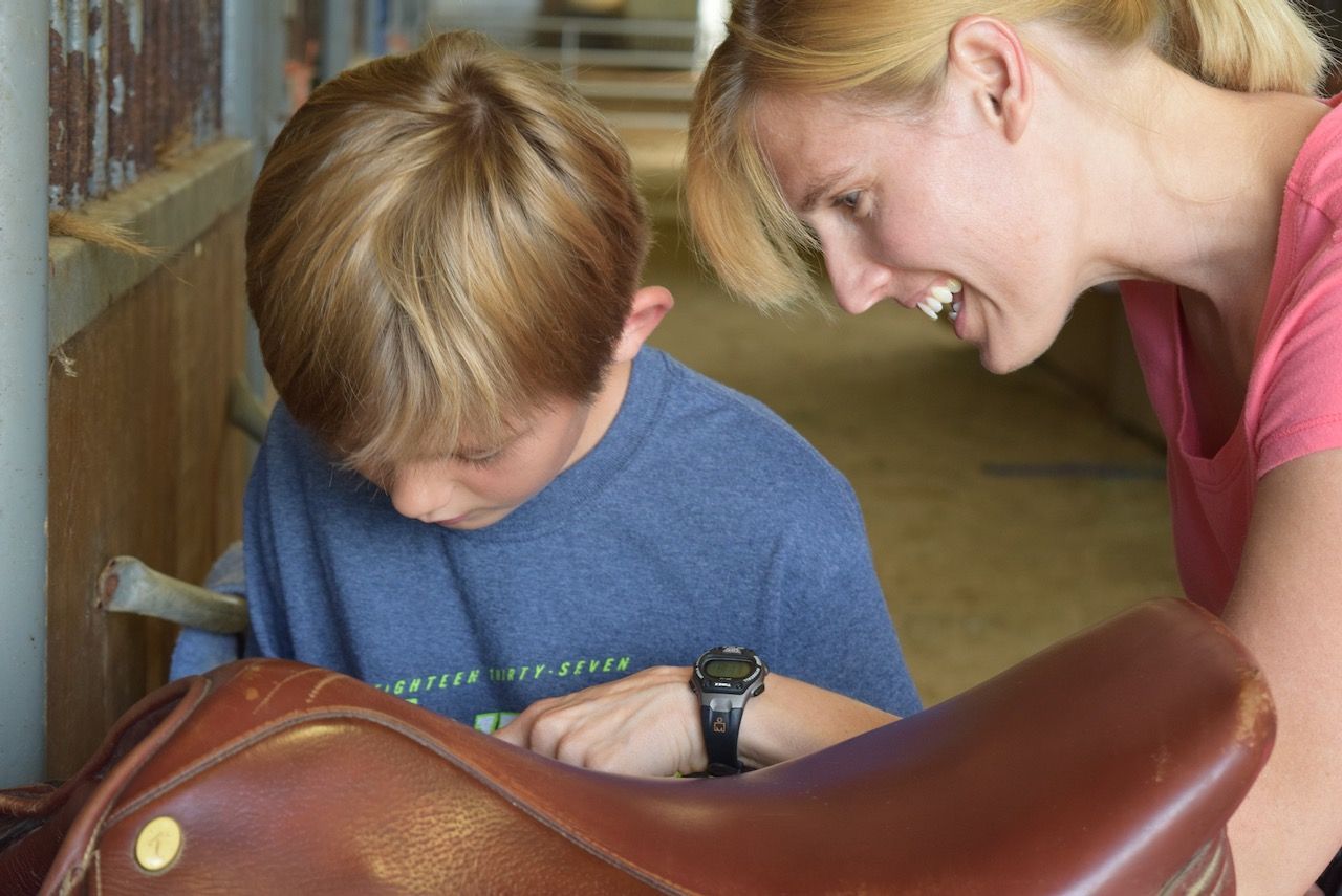 Horse with student and instructor evaluating capabilities.