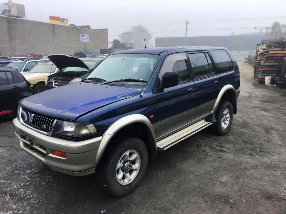 A Blue Vehicle Parked In A Lot