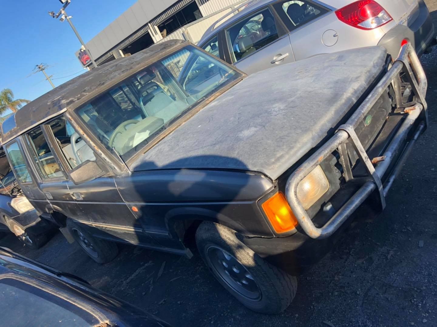 Black SUV With a Rusty Front Guard