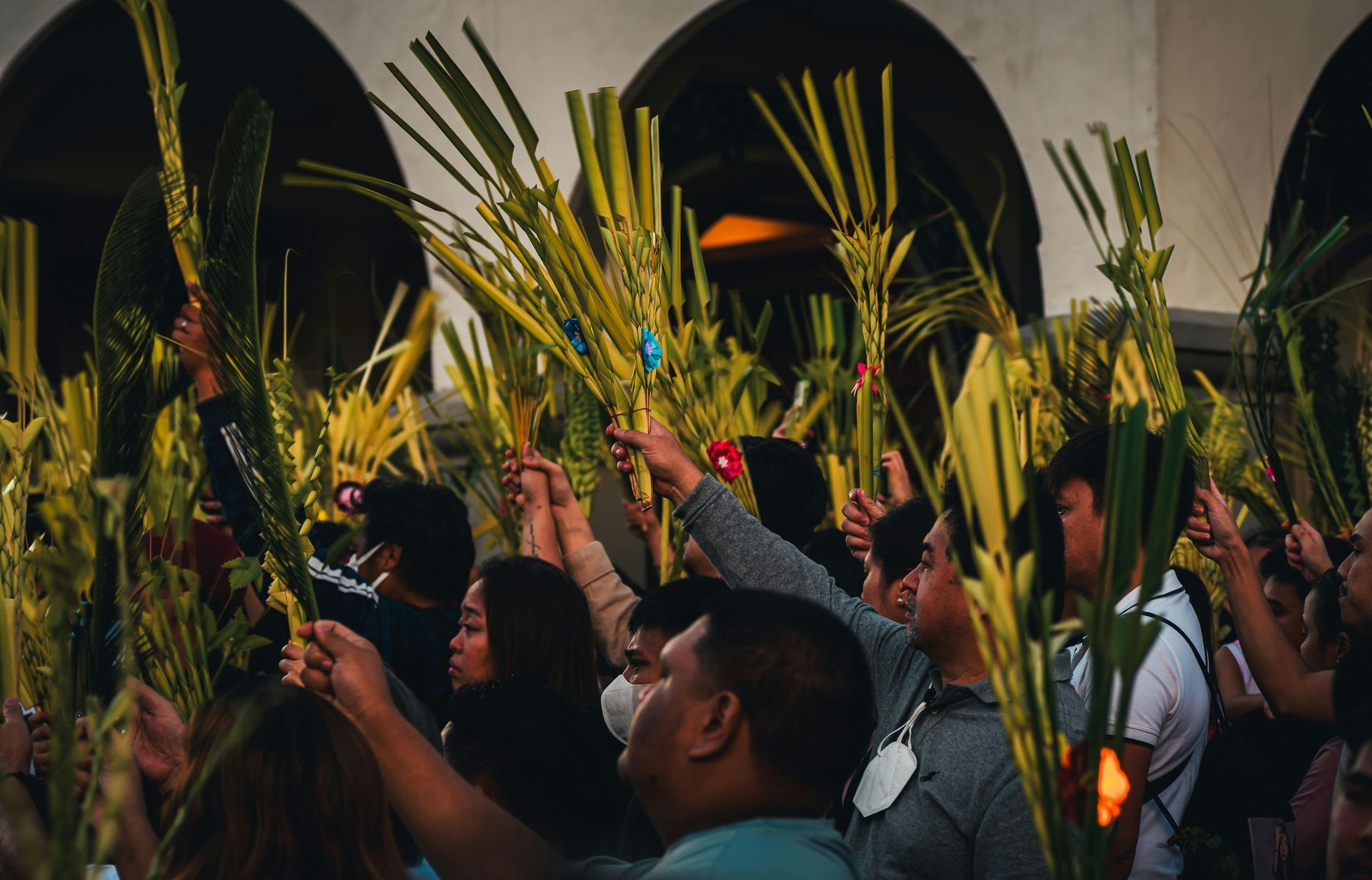 A brick house in the snow with trees in the background