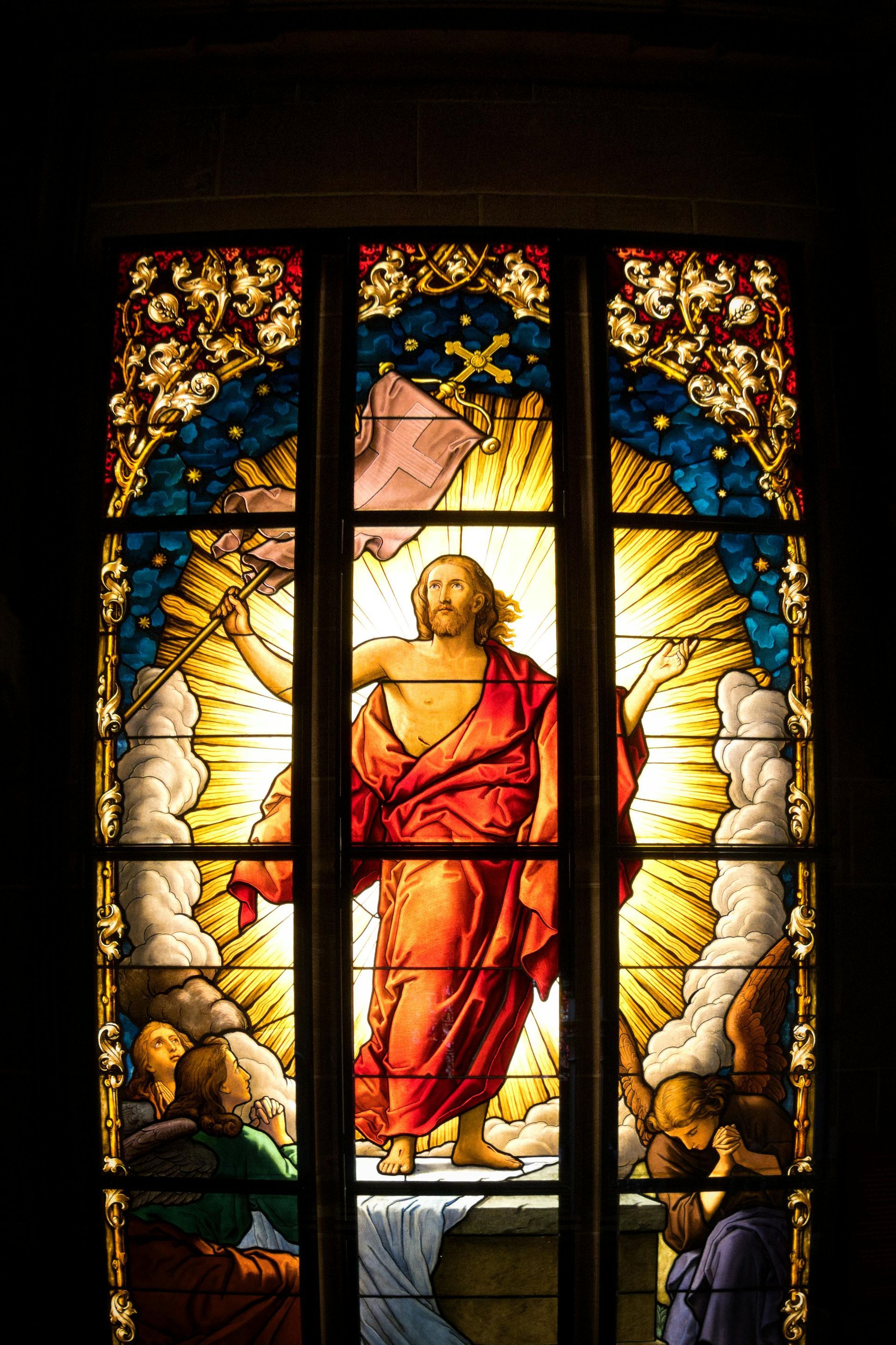 A brick house in the snow with trees in the background