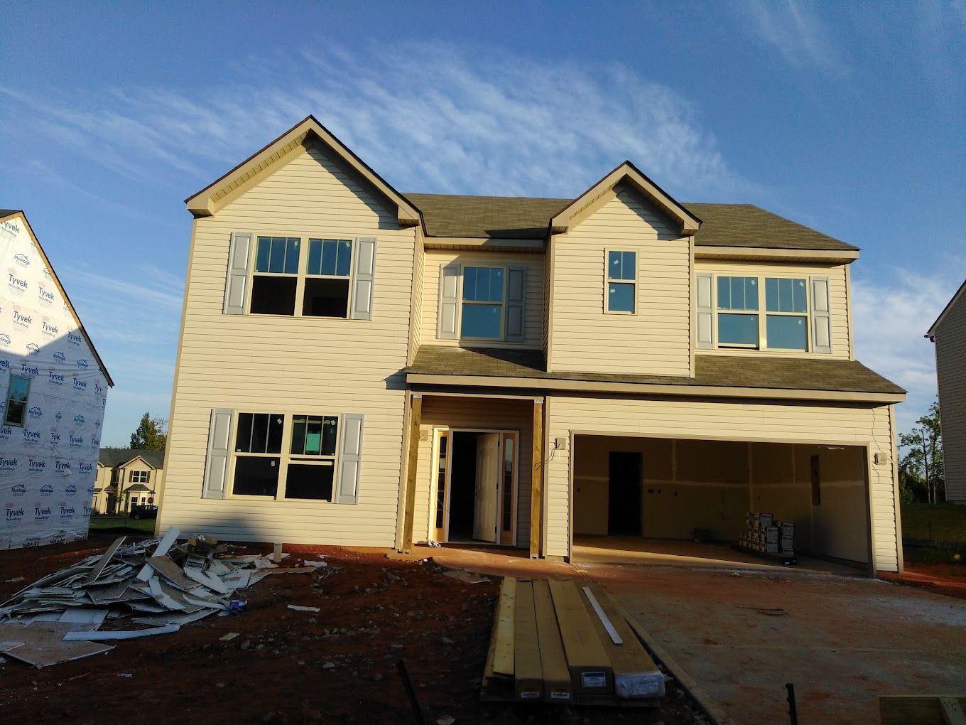 A house that is being built with a lot of windows