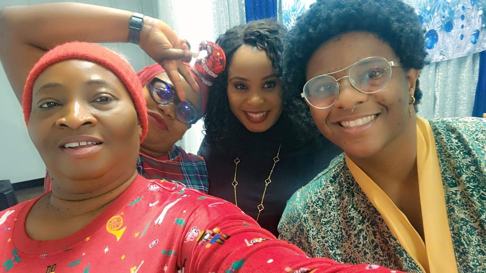A group of people are posing for a picture in a warehouse.