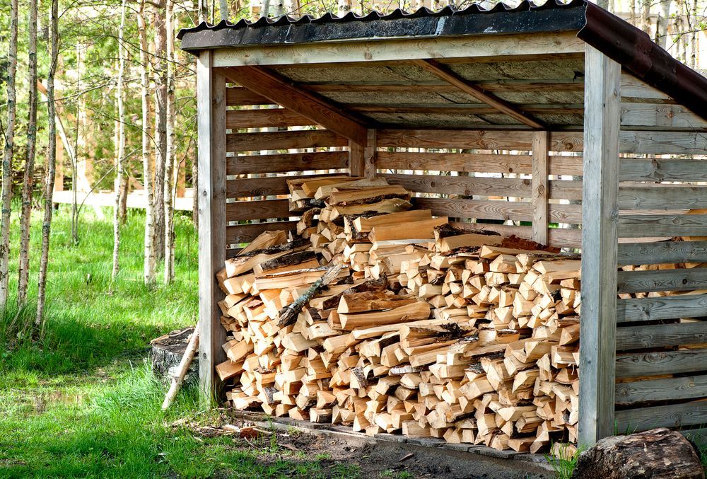 Woodpile Stored in a Wooden Shelter — Tenterfield Timber & Hardware in Tenterfield, NSW