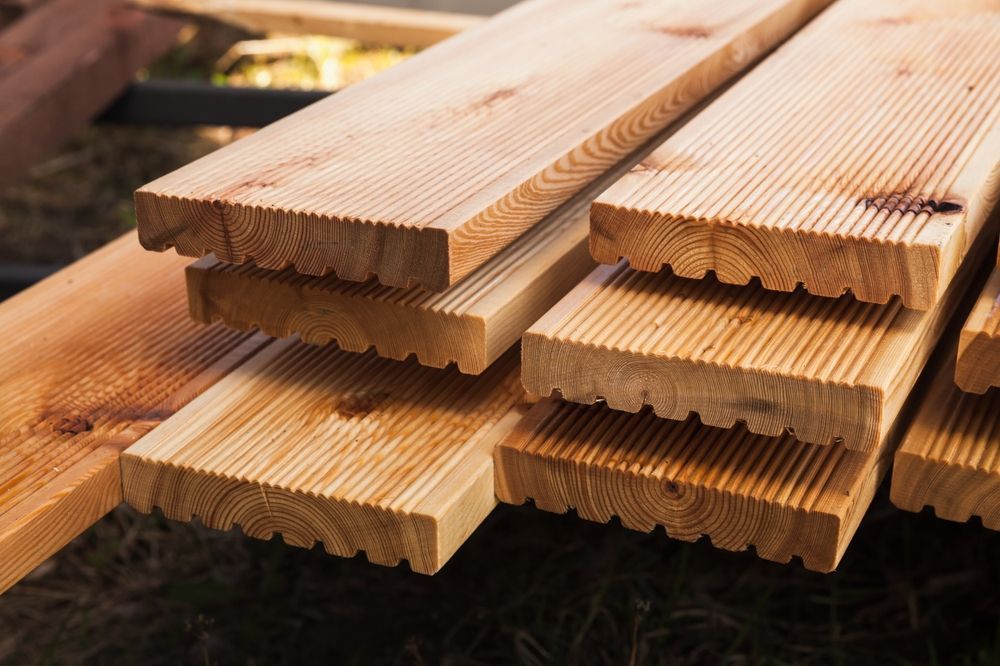 A Pile Of Wooden Boards Stacked On Top Of Each Other — Tenterfield Timber & Hardware in Tenterfield, NSW