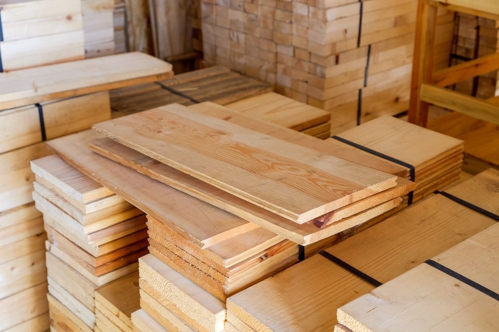 A Bunch Of Wooden Boards Are Stacked On Top Of Each Other In A Warehouse  — Tenterfield Timber & Hardware in Deepwater, NSW