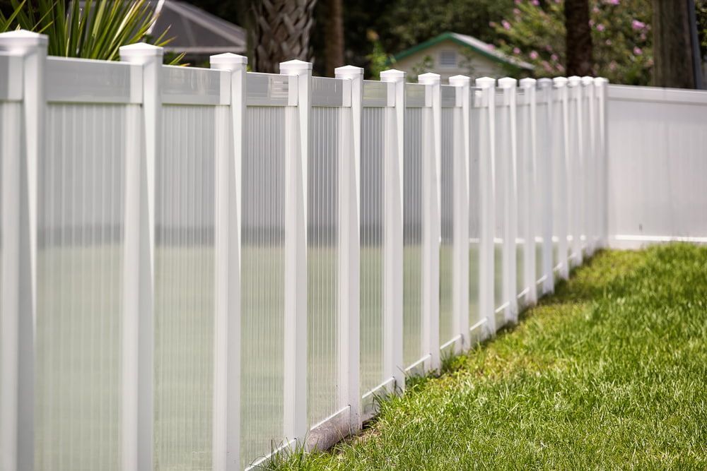 A White Fence Surrounds A Swimming Pool In A Backyard  — Tenterfield Timber & Hardware in Stanthorpe, QLD