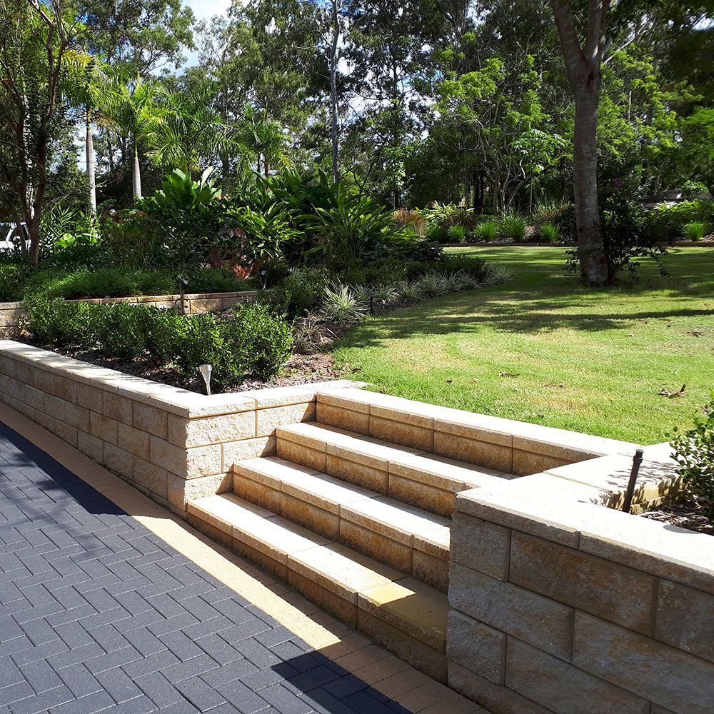 A Table And Chairs Are Sitting On A Stone Patio In A Garden  — Tenterfield Timber & Hardware in Tenterfield, NSW