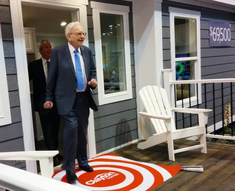 Billionaire investor Warren Buffett from Berkshire Hathaway subsidiary Dairy Queen talks to Kevin Clayton, CEO of Clayton Homes, also a Berkshire subsidiary, at a 2014 shareholders meeting. (Nati Harnik / Associated Press)