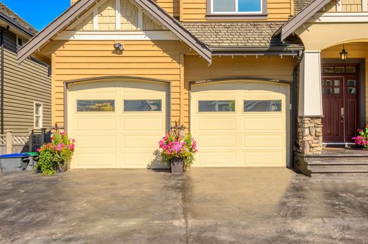 Residential home two door garage door with windows on the top panel