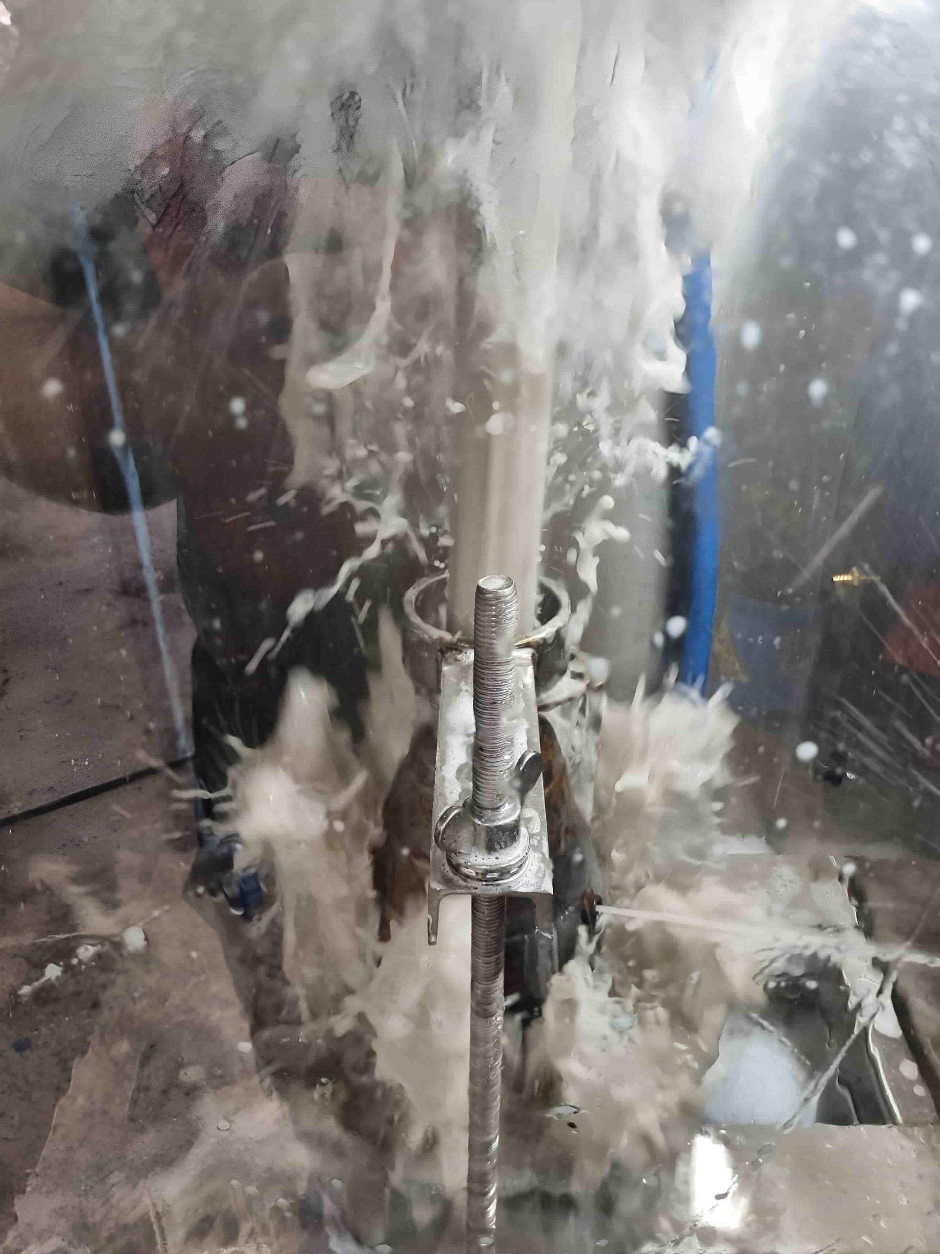 A Close Up of a Person Standing Next to a Pipe With Water Coming Out of It — Regen NT In Holtze, NT