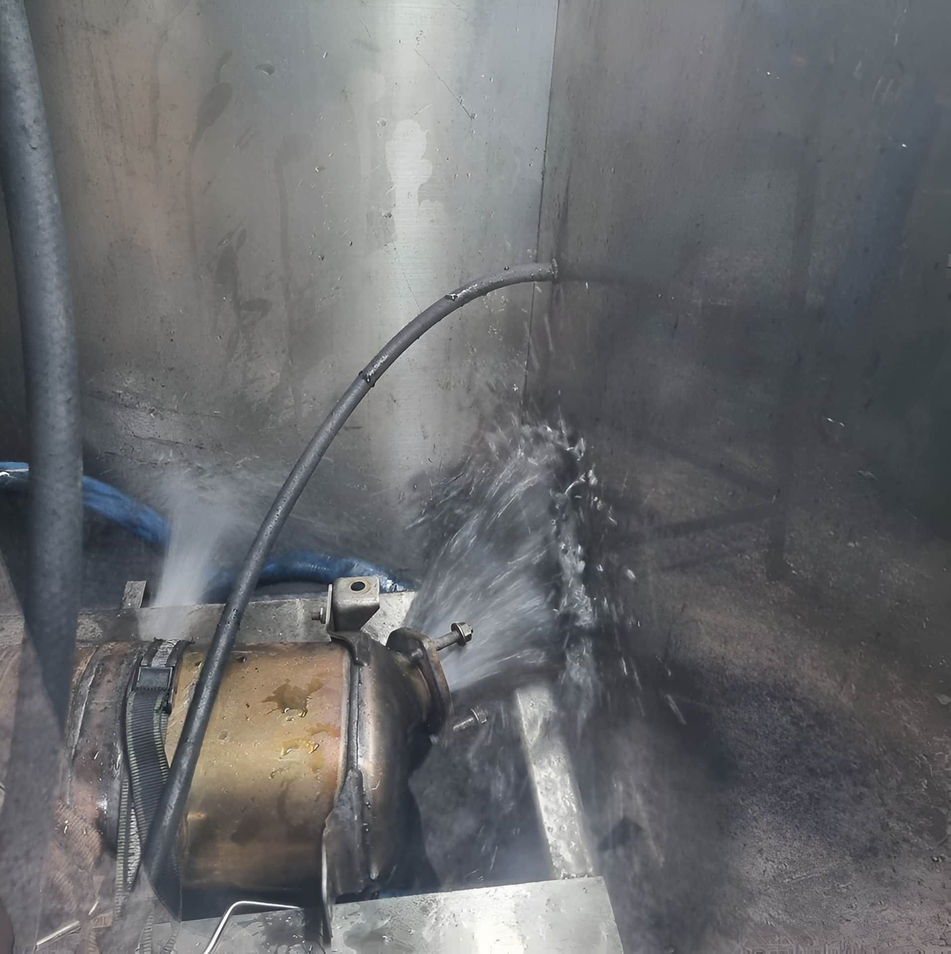 A Hose is Spraying Water on a Metal Object — Regen NT In Holtze, NT