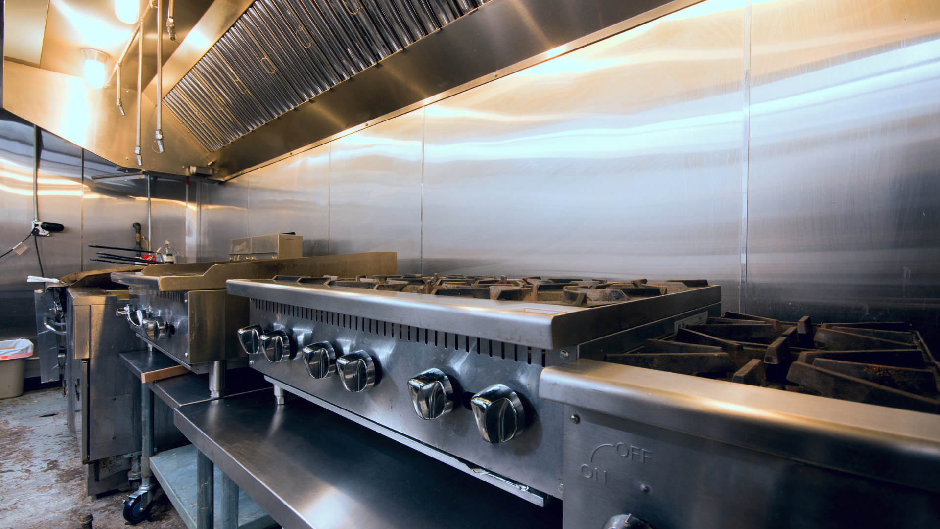 A kitchen with stainless steel appliances and a stove.