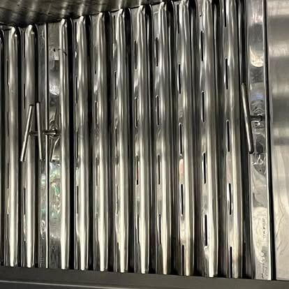 A close up of a stainless steel exhaust hood in a kitchen.