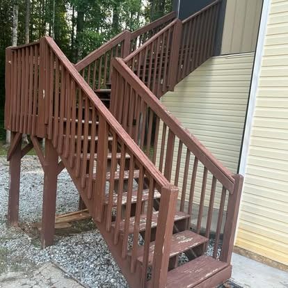 A set of wooden stairs leading up to a house