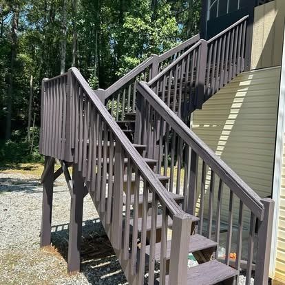 A wooden deck with stairs leading up to it