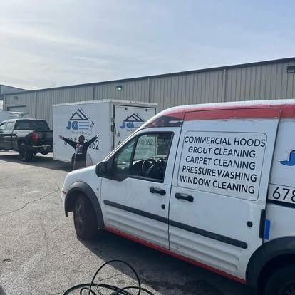 A white van is parked in front of a building.